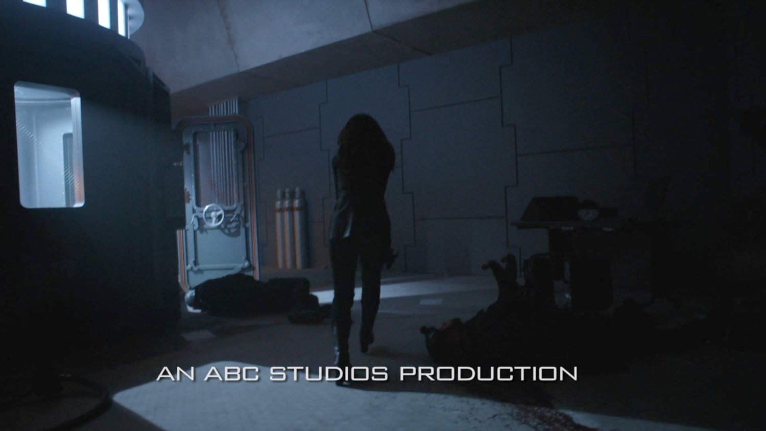 Agent May investigating dead bodies in quantum generator room of Momentum Labs.