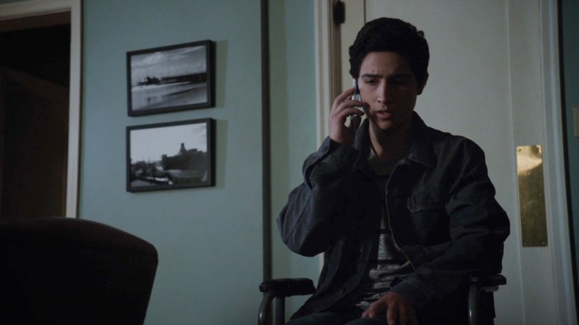 Gabe on the phone inside his house.