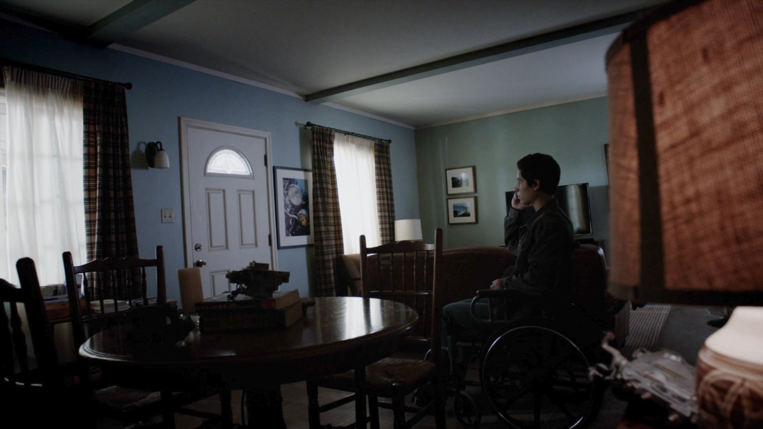 The inside of the Reyes house, with Gabe on the phone.