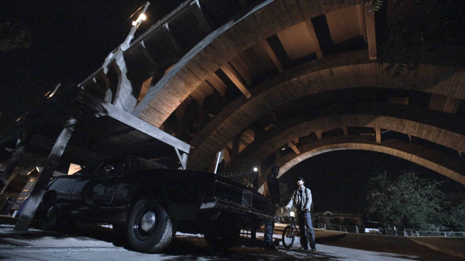 Robbie and Gabe by black Charger under bridge behind Reyes house.