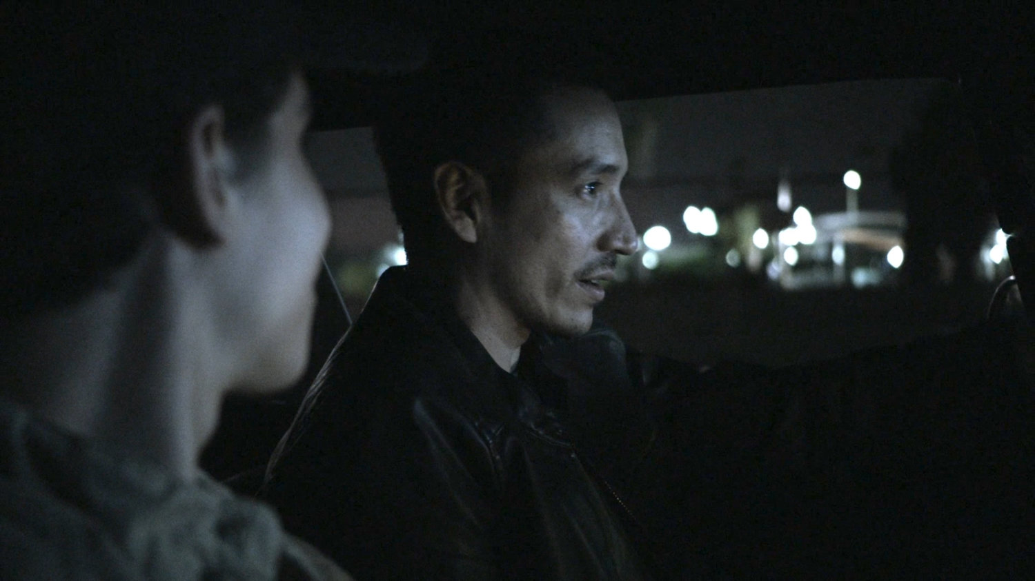 Gabe and Robbie driving on street at night.