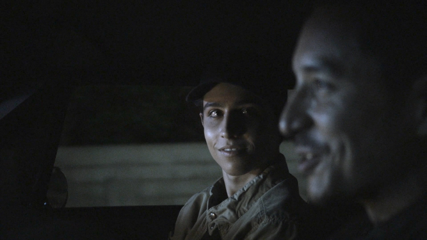 Gabe and Robbie driving on street at night.