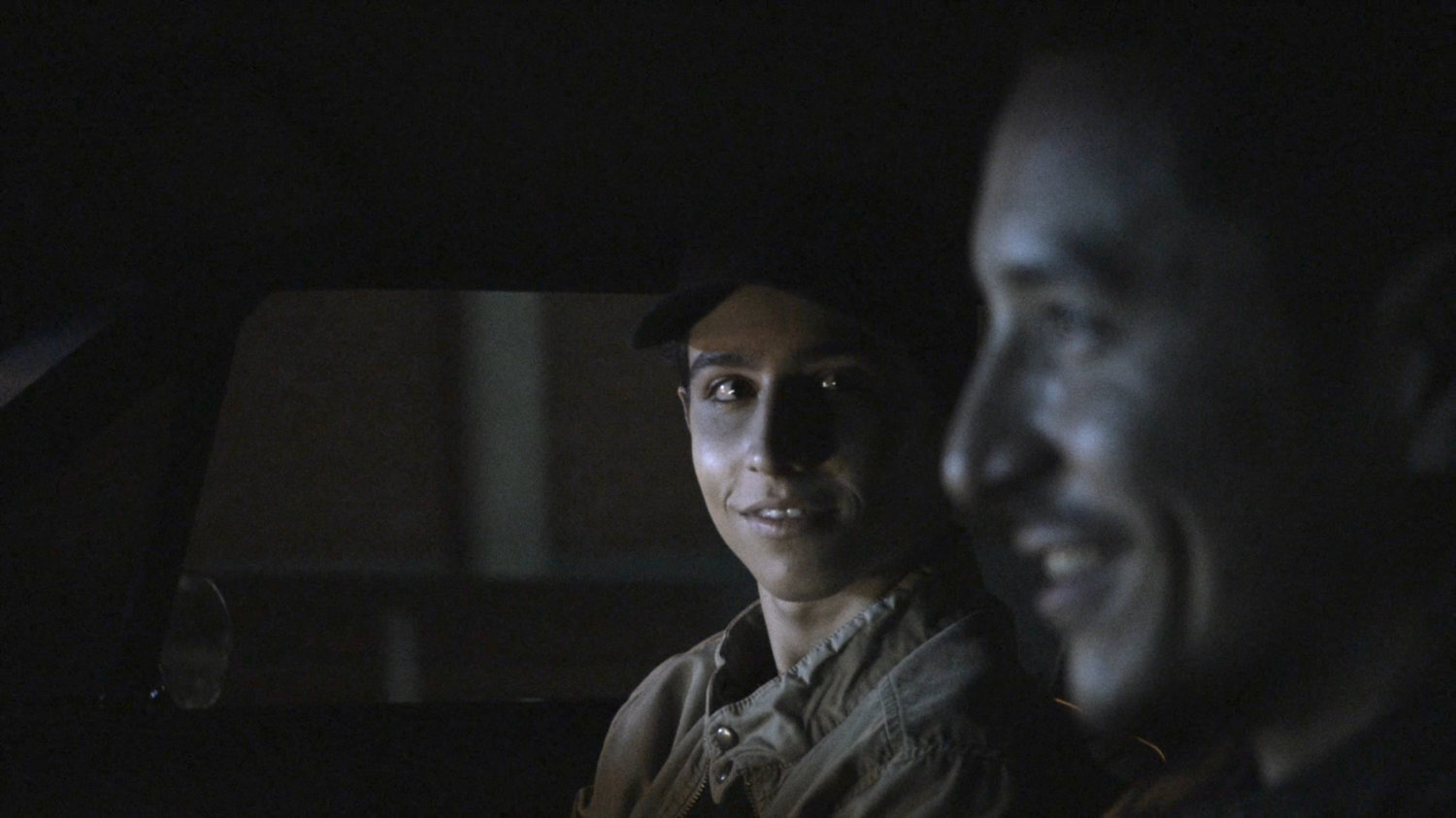 Gabe and Robbie driving on street at night.