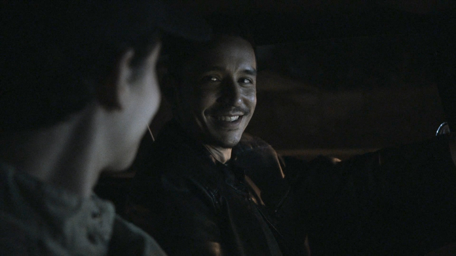 Gabe and Robbie driving on street at night.