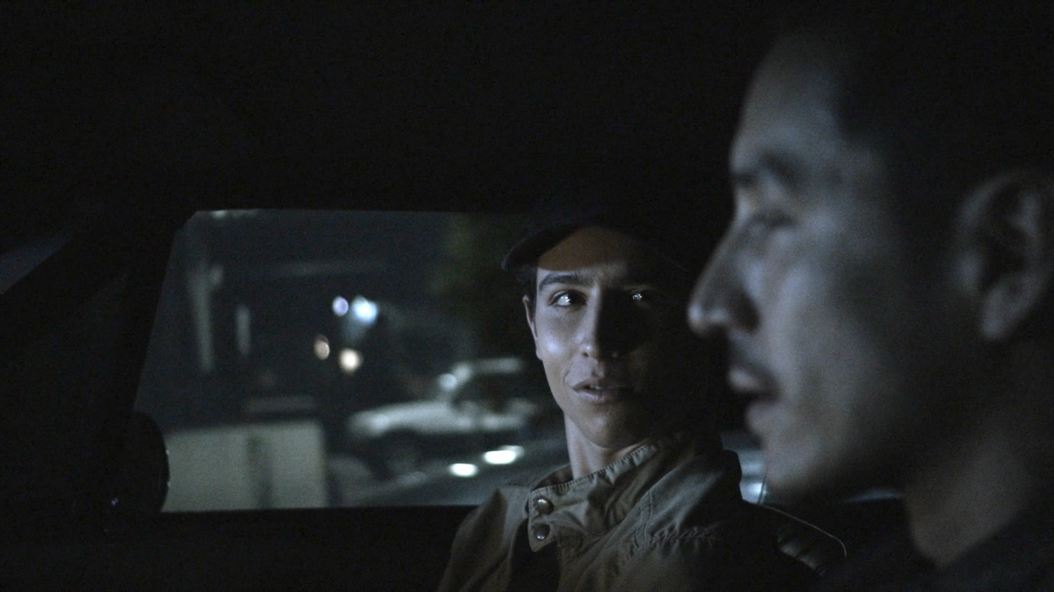 Gabe and Robbie driving on street at night.