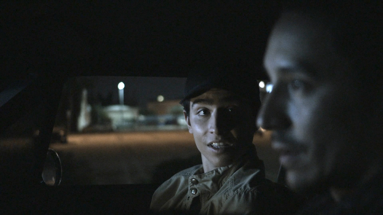 Gabe and Robbie driving on street at night.