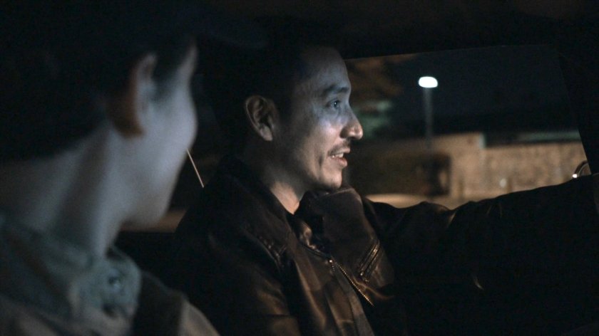 Gabe and Robbie driving on street at night.