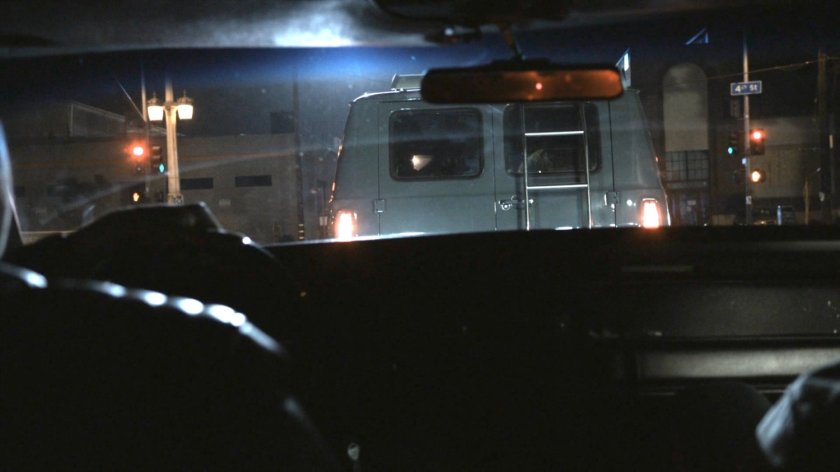 POV from Robbie's car behind a van at an intersection.