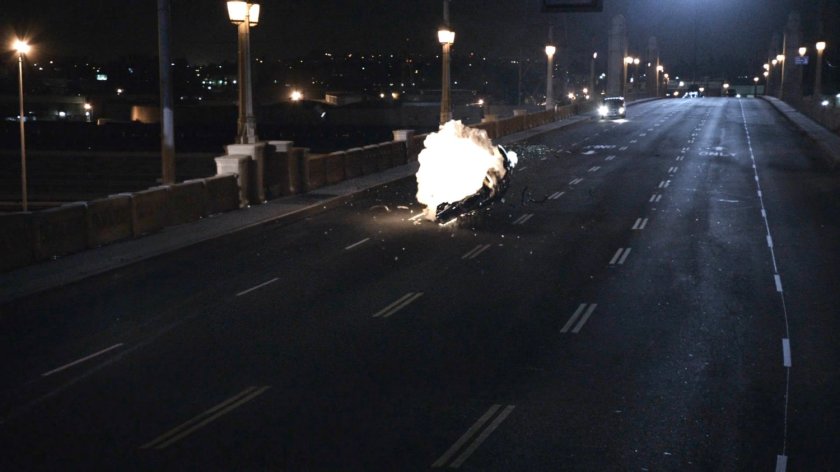 Black Charger exploding in fireball on Los Angeles bridge.