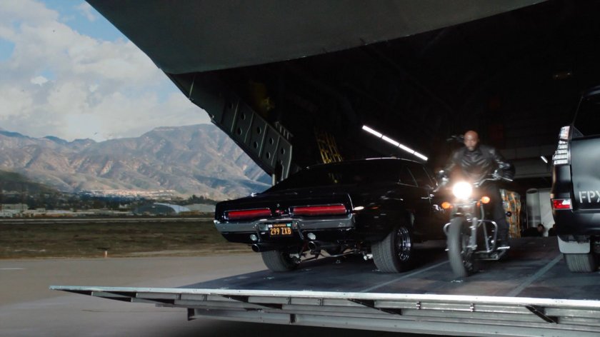 Mack riding his motorcycle off the ramp of Zephy One at a Los Angeles airfield.