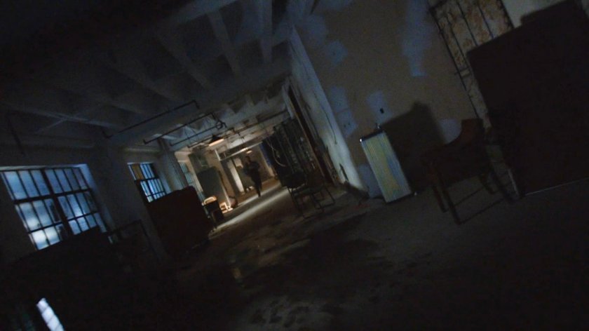 A man running through a hallway in the quantum cube warehouse.