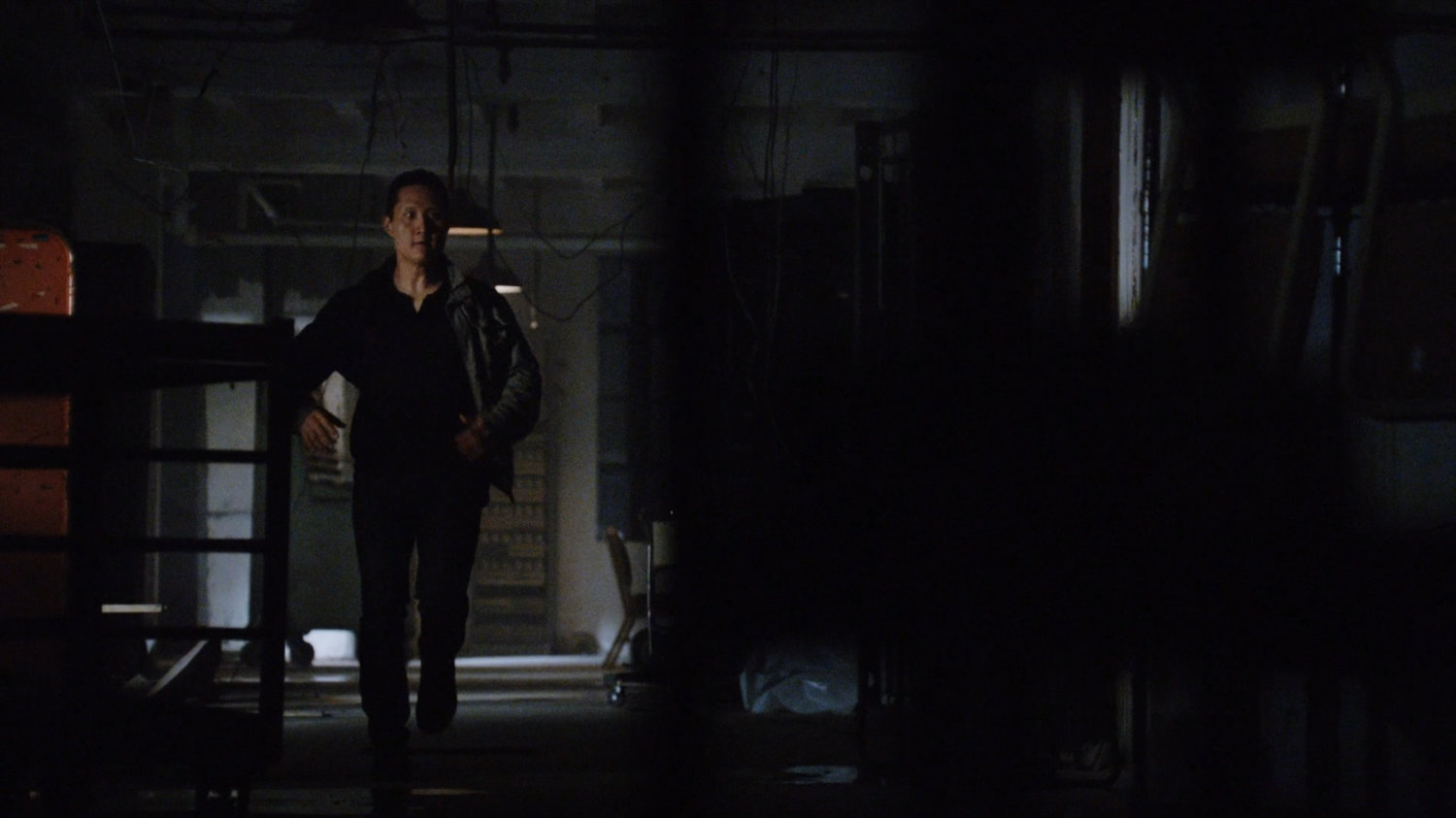 A man running through a hallway in the quantum cube warehouse.