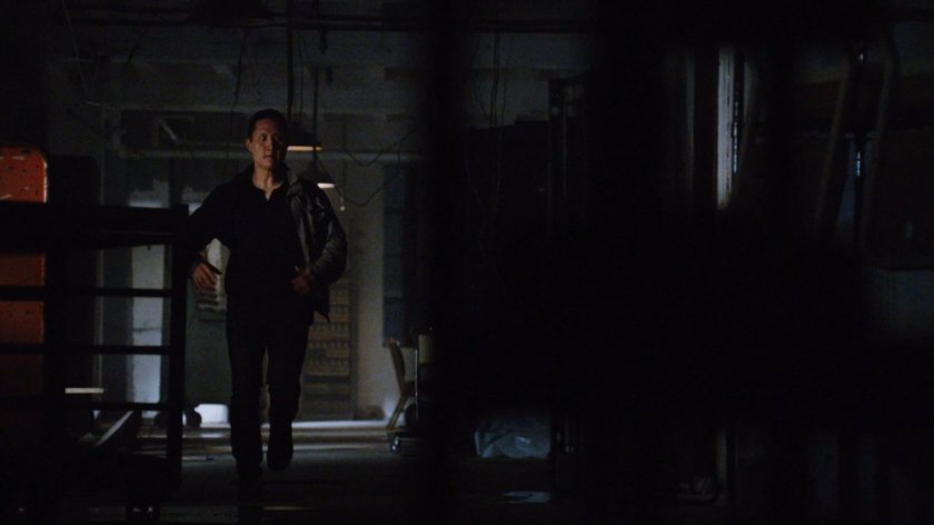 A man running through a hallway in the quantum cube warehouse.