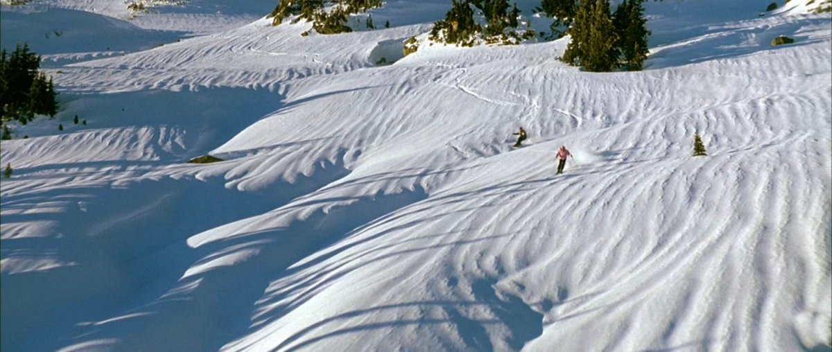 Johnny and nurse skiing down snowy mountains near the Von Doom compound.
