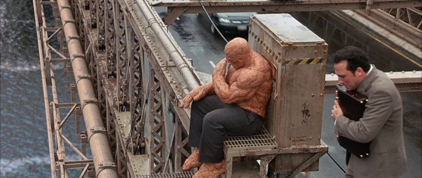 Ben sitting on the Brooklyn Bridge and a business man standing about to jump.