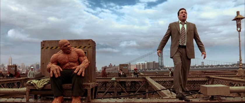 Ben sitting on the Brooklyn Bridge and a business man standing about to jump.