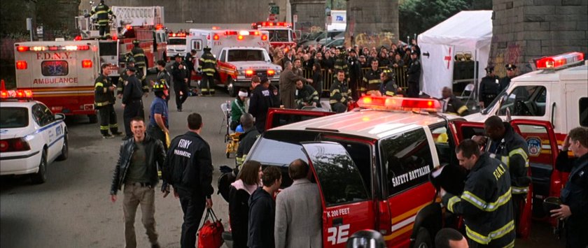 Johnny surrounded by emergency personnel under the Brooklyn Bridge.