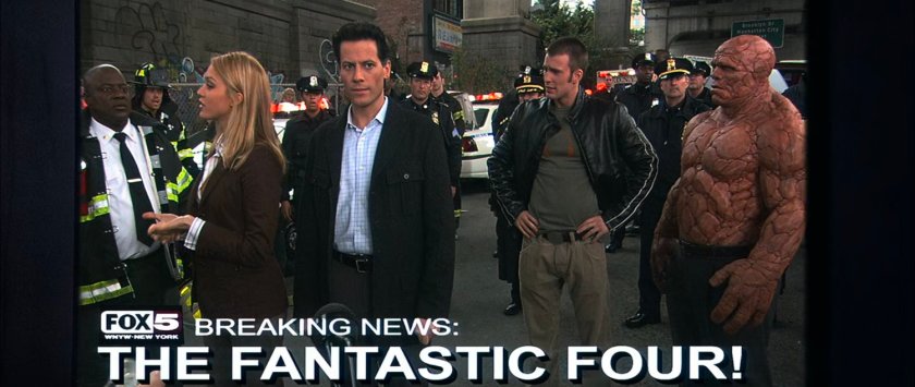 TV footage of Sue, Reed, Ben, and Johnny under the Brooklyn Bridge. Text: Breaking News: The Fantastic Four!