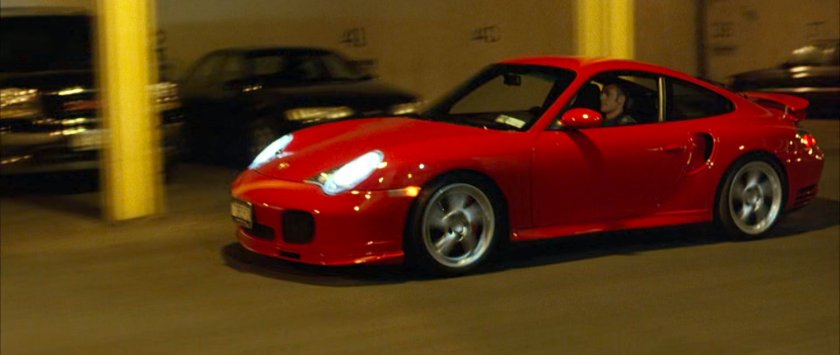 Johnny driving his car through the Baxter Building garage.
