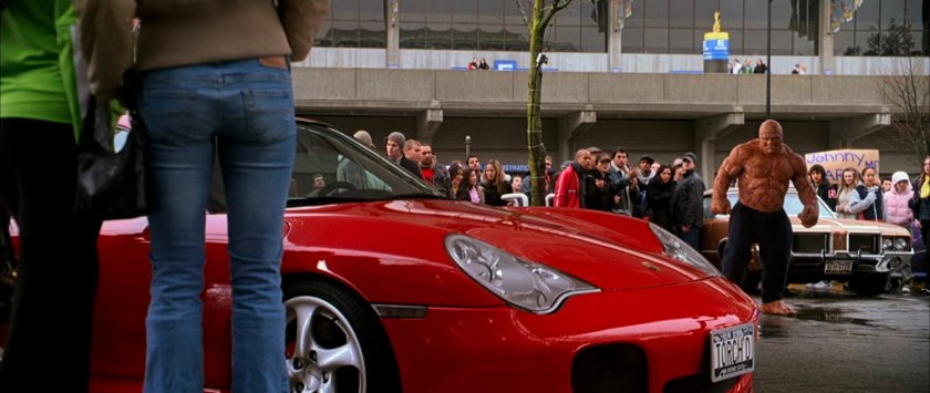 Ben looking at a red Ferrari at the entrance at the XGames Arena.
