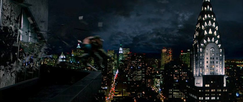 Doom and Ben fly through window outside Von Doom Industries tower, with the Chrysler Building in the background.