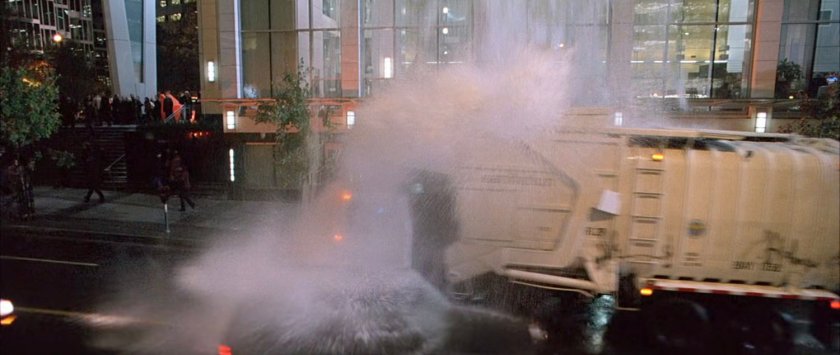 Water landing on a trash truck at a New York intersection.