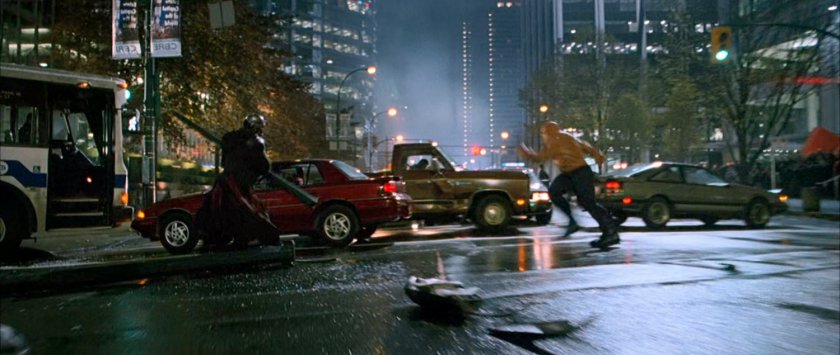 The Thing charges Doctor Doom in a New York intersection.