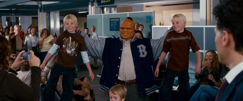 The Thing lifting two young boys by their shirts in an airport.