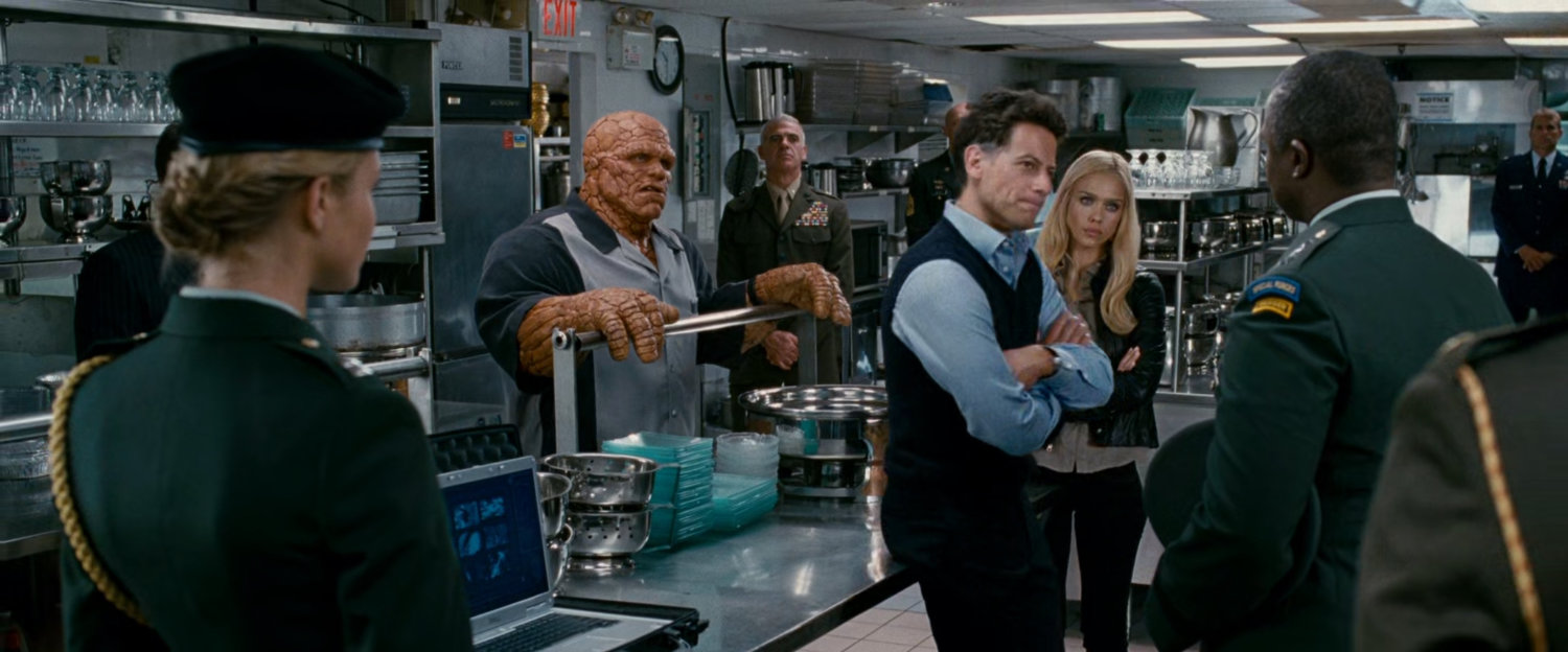 Reed, Ben and Sue talking with General Hager in a kitchen at a club.