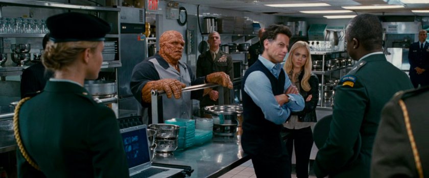 Reed, Ben and Sue talking with General Hager in a kitchen at a club.