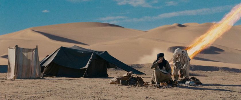 The Human Torch crashing into a sand dune by some Bedouins.