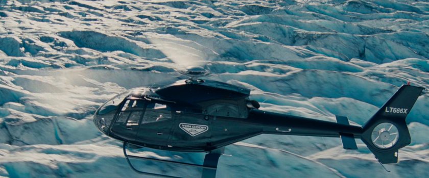 Helicopter flying over a glacier.