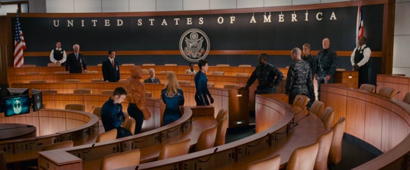 The Fantastic Four in a conference center speaking with General Hager.