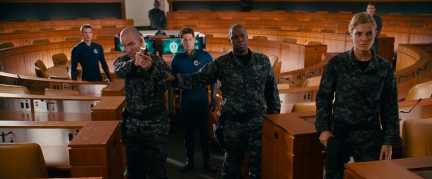 The Fantastic Four in a conference center speaking with General Hager.