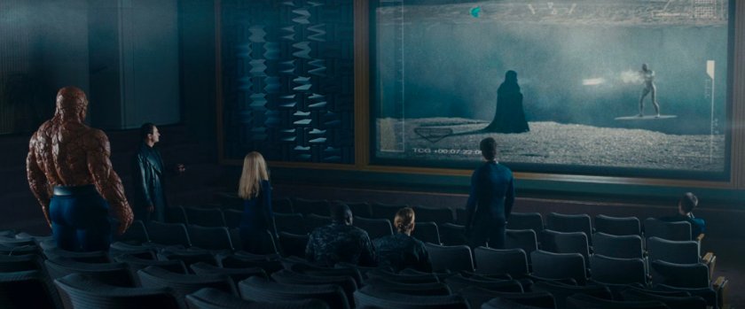 The Fantastic Four watching footage of Doom's confrontation with the Silver Surfer in a theater.