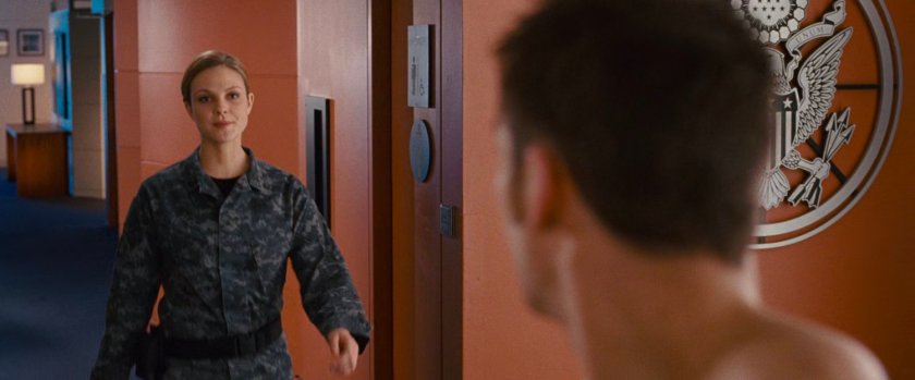 Captain Raye and Johnny in a hallway.