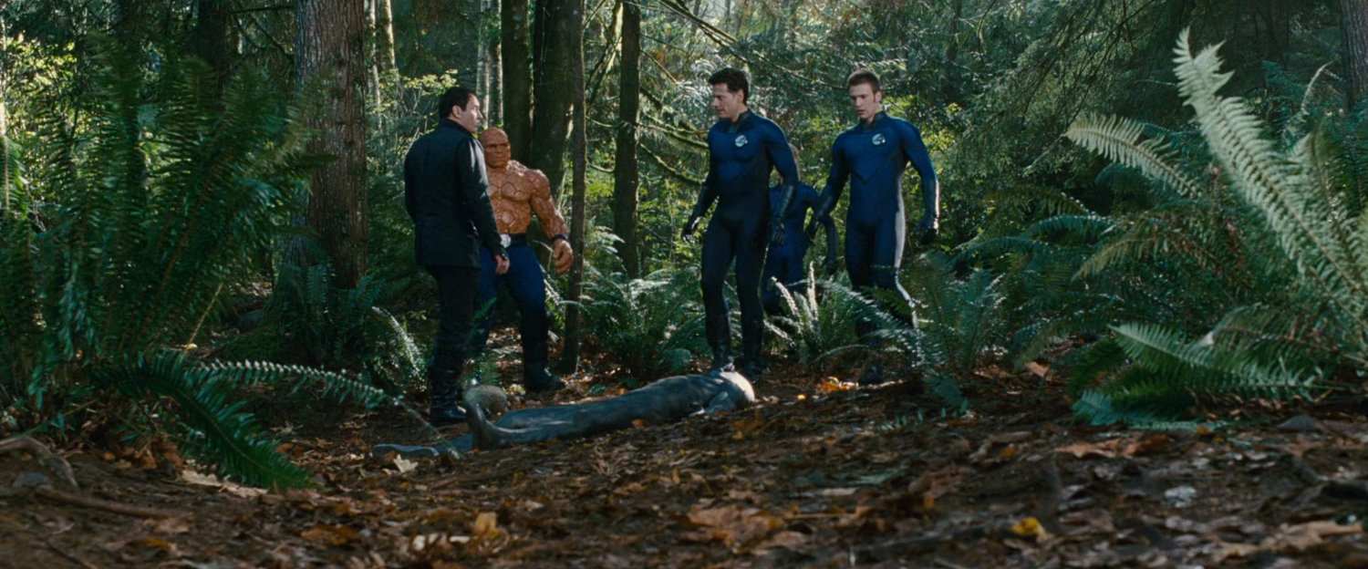 Victor and the Fantastic Four standing above the unconscious Silver Surfer.
