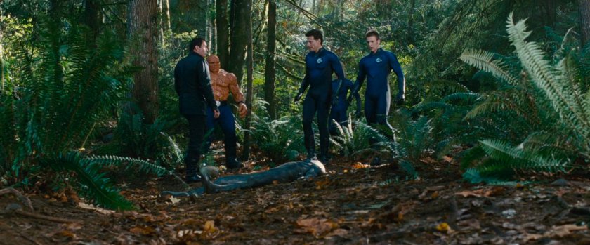 Victor and the Fantastic Four standing above the unconscious Silver Surfer.