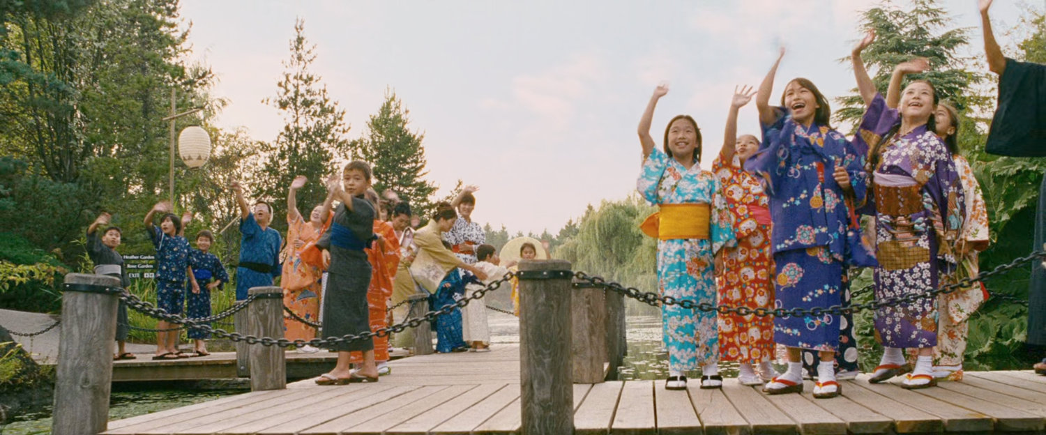 Japanese citizens wave at the departing Fantasticar.