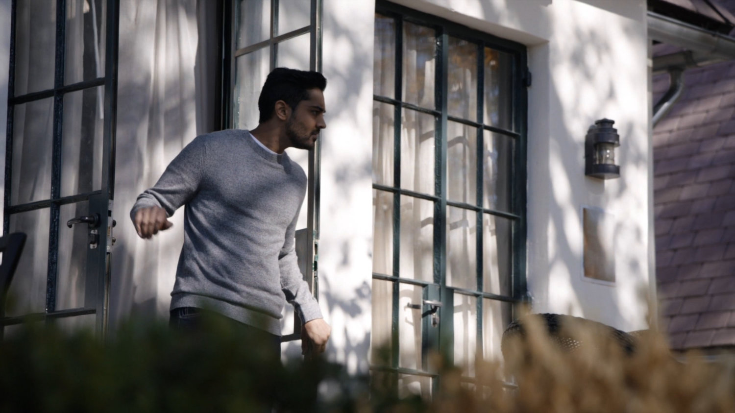 Vijay exiting his sister's lake house.