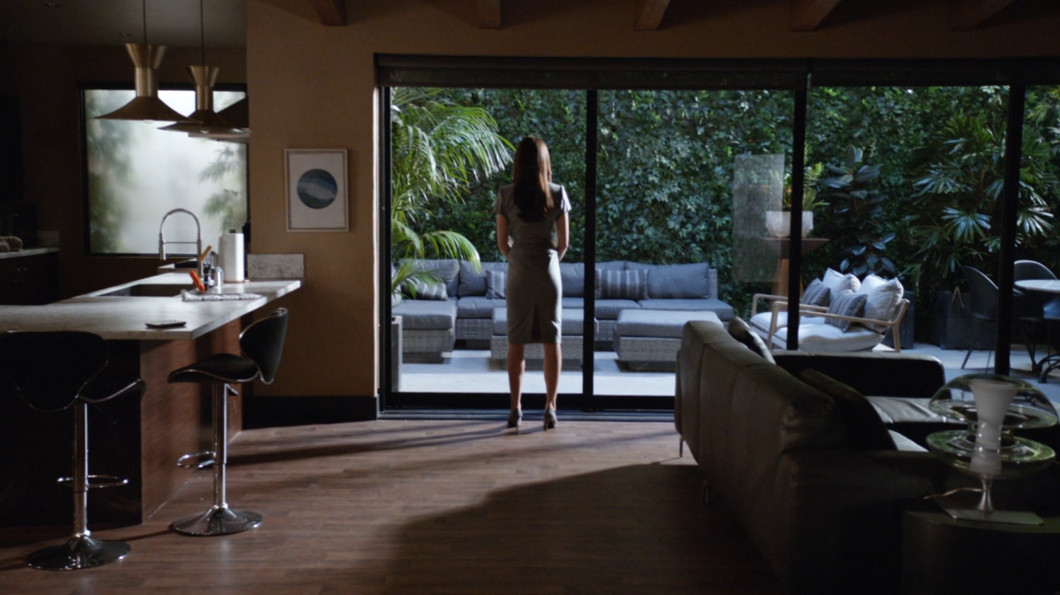 Aida looking out window at Radcliffe's house.