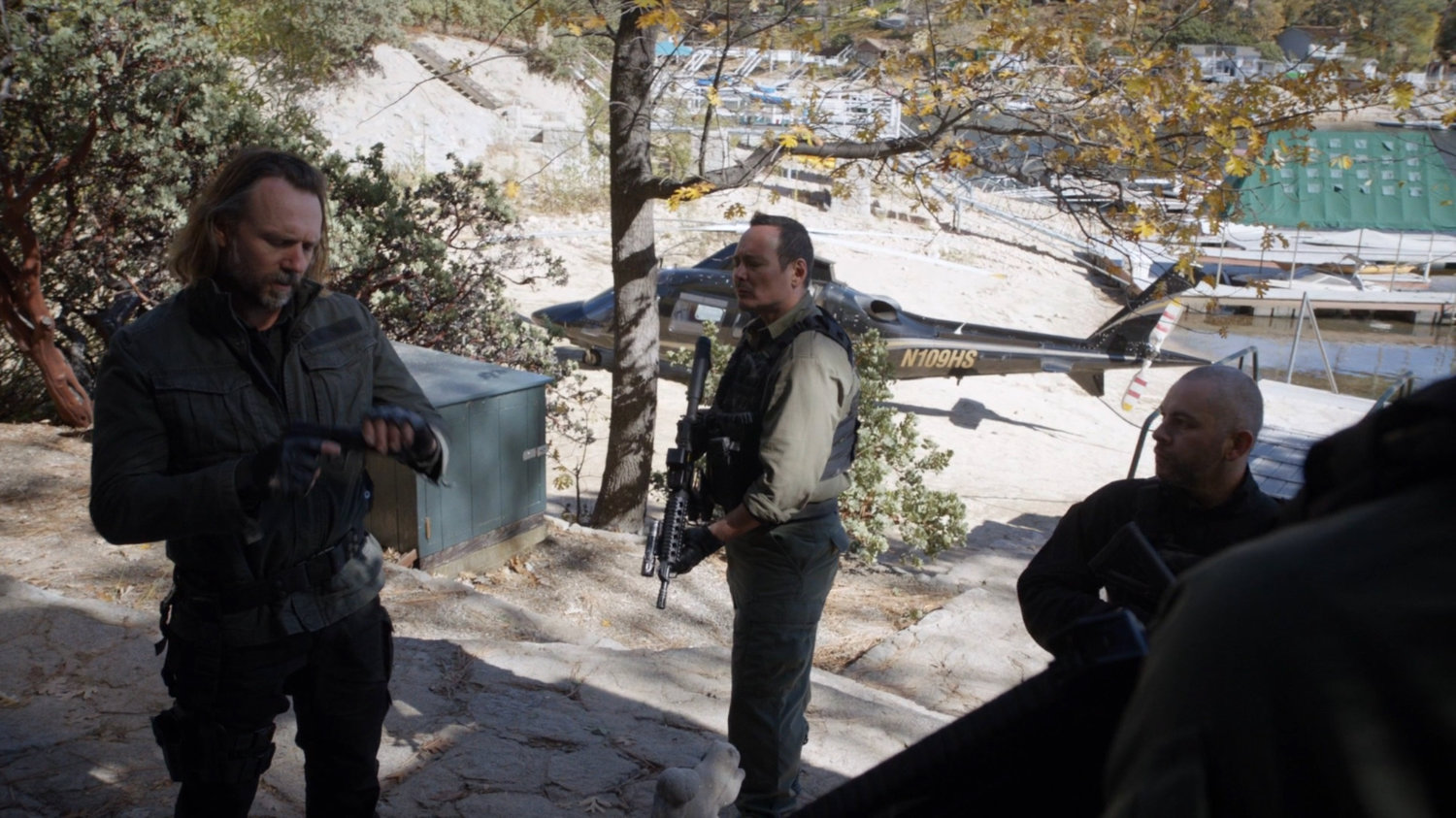 Shockley and other Watchdogs outside Nadeer's lake house.