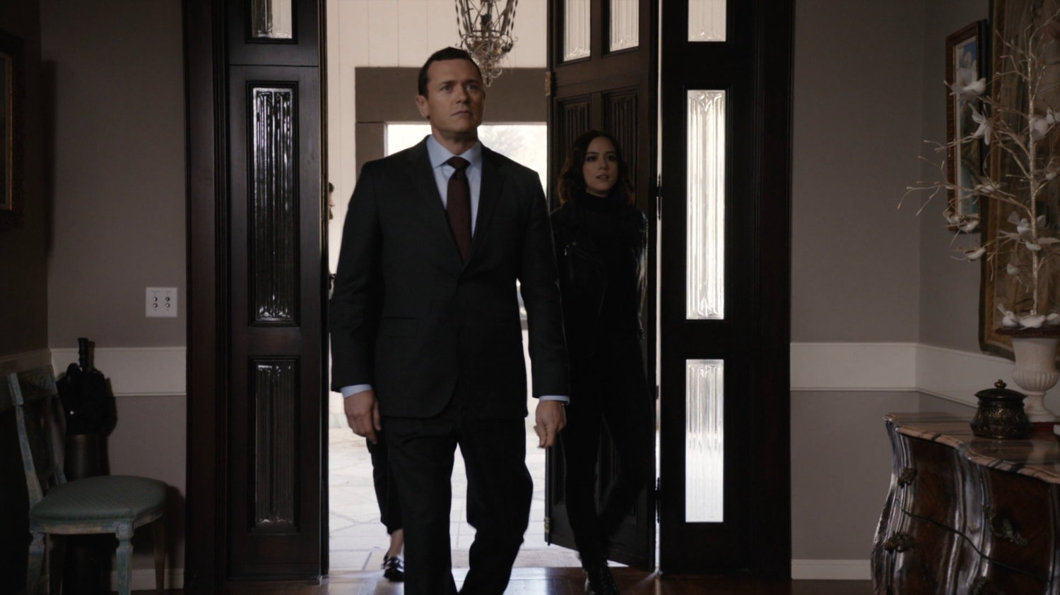 Director Mace and Daisy enter Ellen Nadeer's lake house.