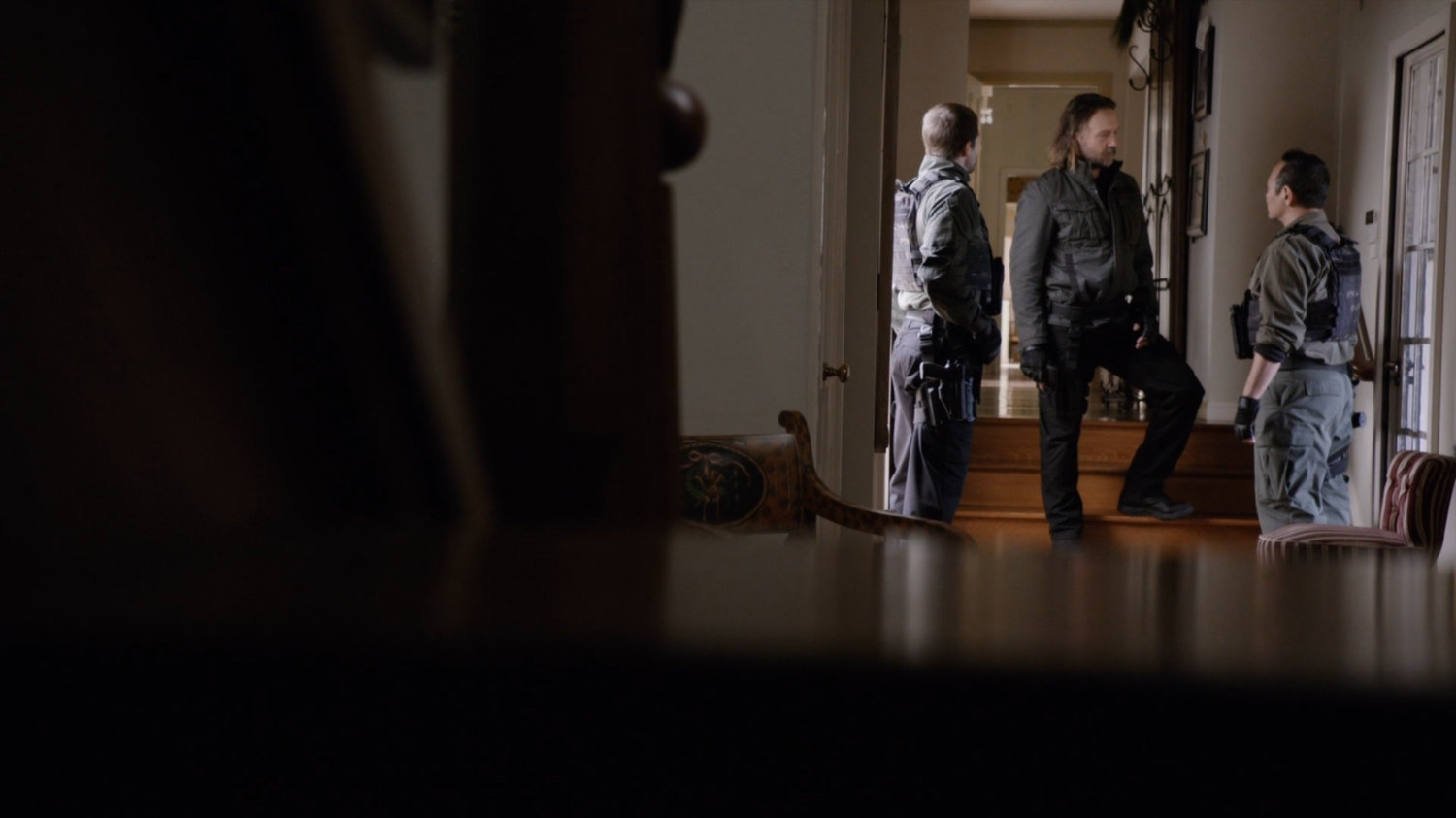 Shockley and two Watchdogs in Nadeer's lake house.