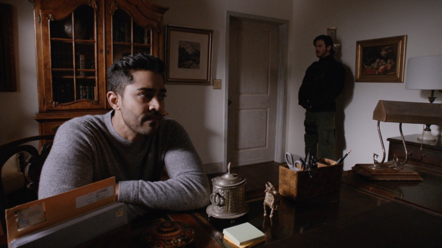 Vijay and guard in Ellen Nadeer's lake house.