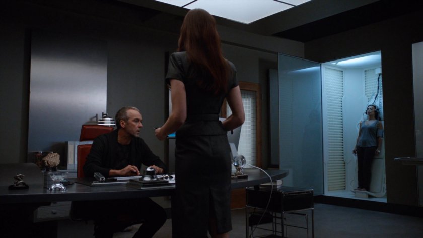 Radcliffe and Aida in his workshop with Agent May unconscious in a cubicle.