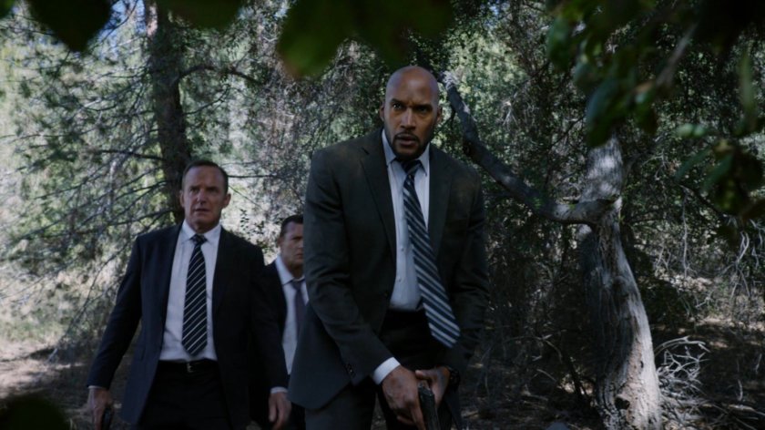 Director Mace, Coulson, and Mack in a rural West Virginia forest.