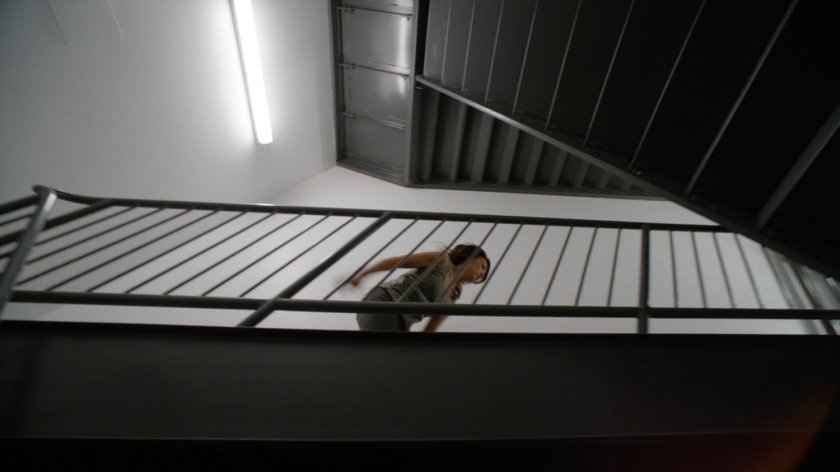 Agent May running up a stairway in the Framework.