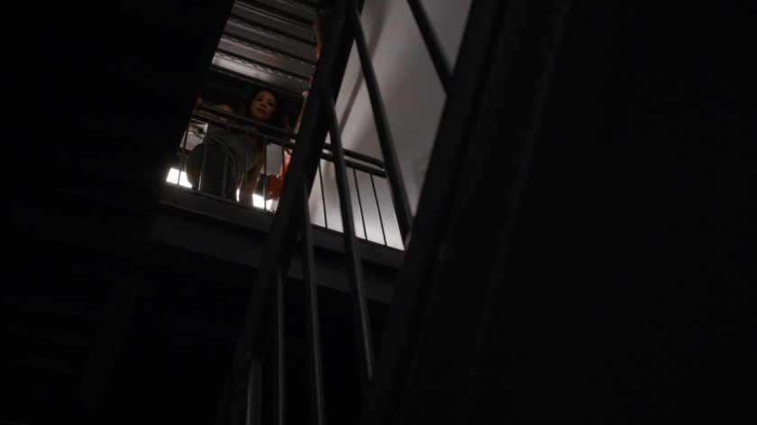 Agent May at the top of a stairway in the Framework.