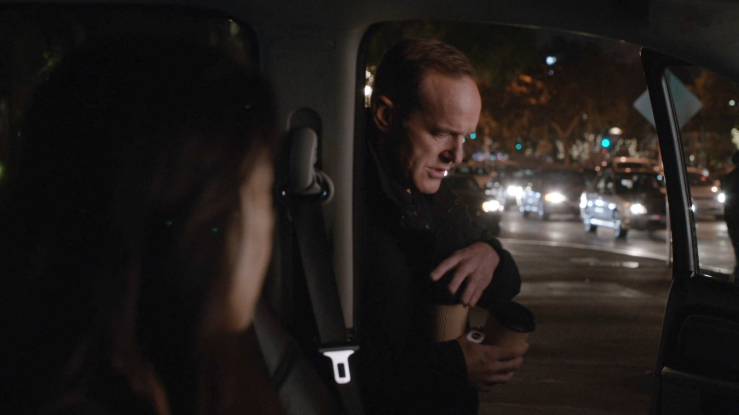 Coulson getting into car with coffee outside the Soul Patch.